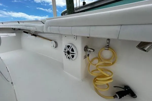 Slide: The Image of 2018 Regulator 23 Forward Seating boat interior with speaker and coiled hose. - 32