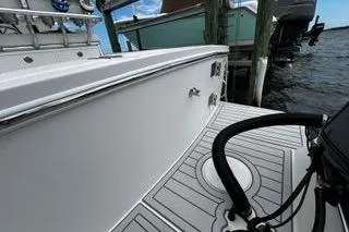 Slide: The Image of 2018 Regulator 23 Forward Seating boat docked by the water. - 4