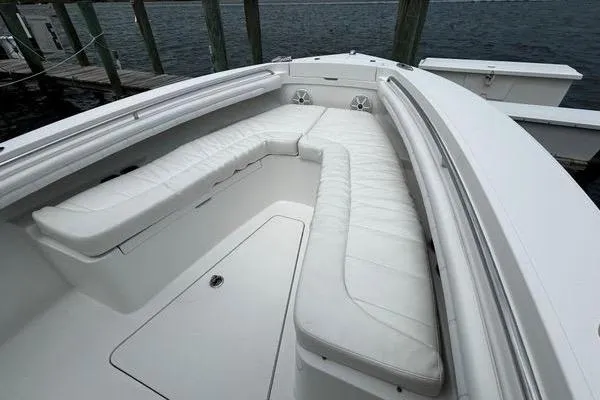 Slide: The Image of 2018 Regulator 23 Forward Seating boat with spacious white cushioned seating area. - 41