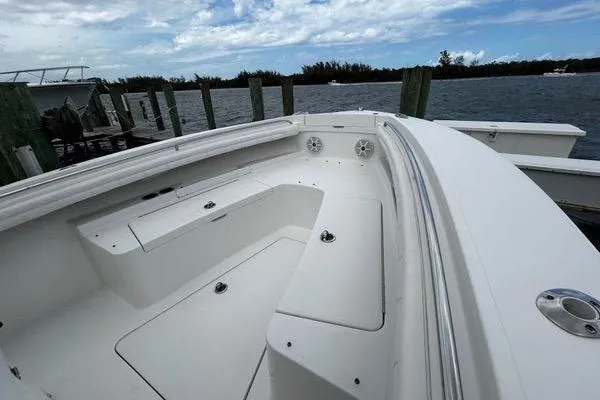 Slide: The Image of 2018 Regulator 23 Forward Seating boat docked by the water. - 42