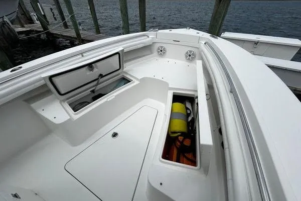 Slide: The Image of 2018 Regulator 23 Forward Seating boat with open storage compartments and safety equipment. - 43