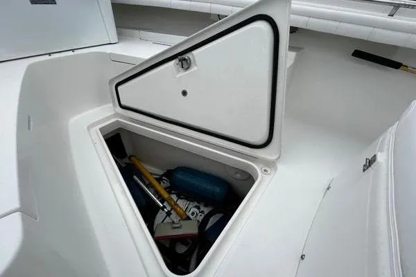Slide: The Image of Open storage compartment on 2018 Regulator 23 Forward Seating boat, containing various items. - 44