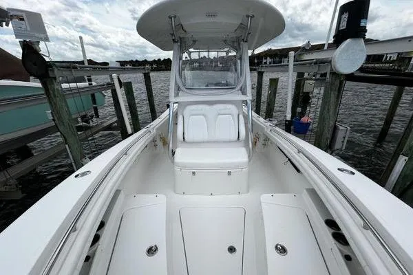 Slide: The Image of 2018 Regulator 23 Forward Seating boat docked, showcasing spacious seating and sleek design. - 47