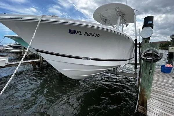Slide: The Image of 2018 Regulator 23 Forward Seating boat docked, displaying registration FL 8664 RL. - 52