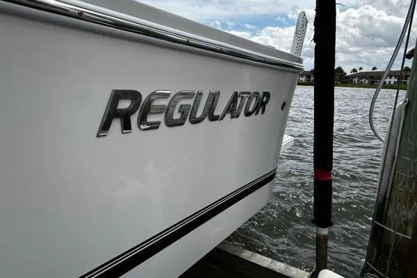 Slide: The Image of 2018 Regulator 23 Forward Seating boat docked by the water. - 53