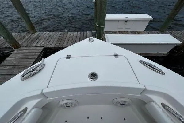 Slide: The Image of Bow view of 2018 Regulator 23 Forward Seating boat docked by wooden pier. - 55