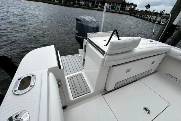 Slide: The Image of 2018 Regulator 23 Forward Seating boat with sleek deck design and outboard motor. - 7