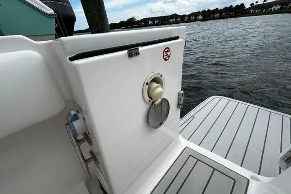 Slide: The Image of 2018 Regulator 23 Forward Seating boat, featuring a clean deck and water view. - 8