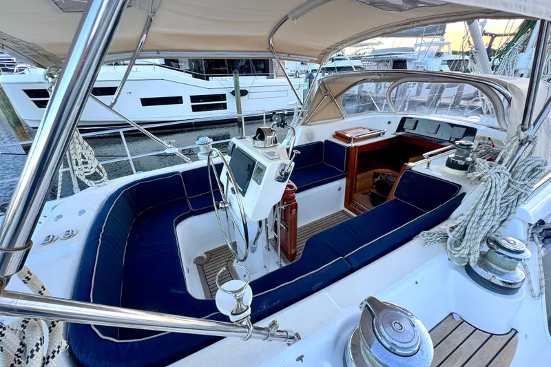 Slide: The Image of 2009 Hylas 54 yacht cockpit with blue seating, steering wheel, and nautical equipment. - 10
