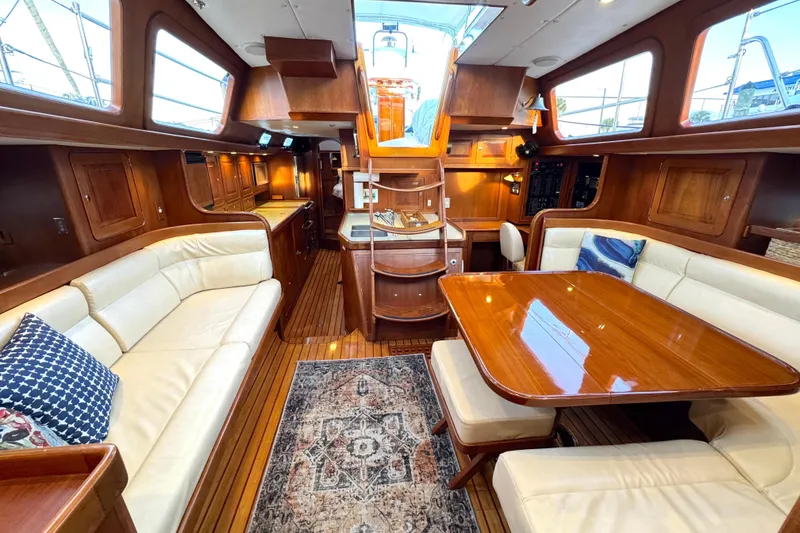 Slide: The Image of Luxurious interior of a 2009 Hylas 54 yacht with elegant wood finishes and plush seating. - 12