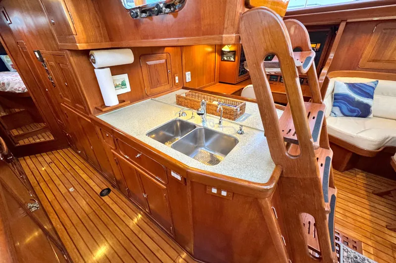Slide: The Image of Luxurious 2009 Hylas 54 yacht interior with wooden cabinetry and modern kitchen amenities. - 17