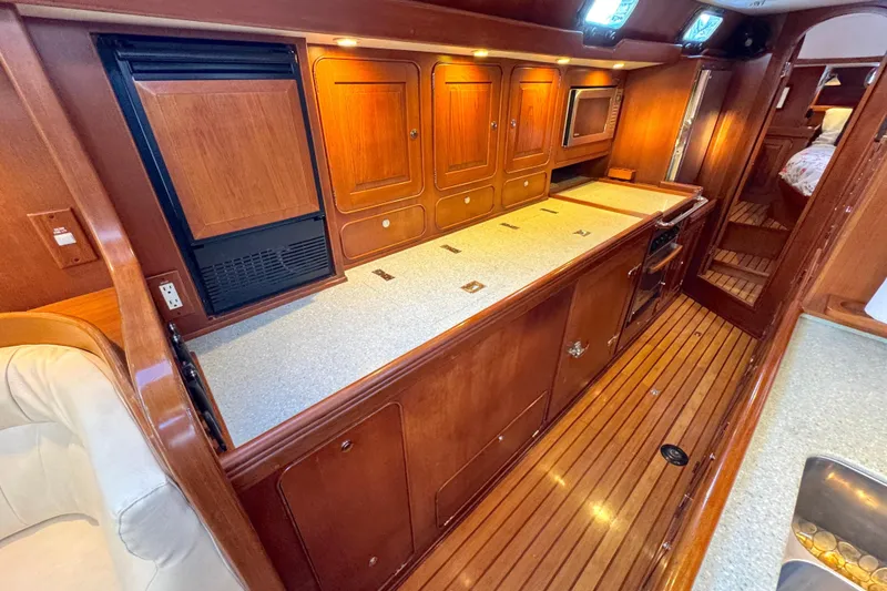 Slide: The Image of Luxurious 2009 Hylas 54 yacht interior with wooden cabinetry and modern amenities. - 18