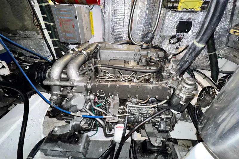 Slide: The Image of Engine room of a 2009 Hylas 54 yacht, showcasing detailed machinery and components. - 24