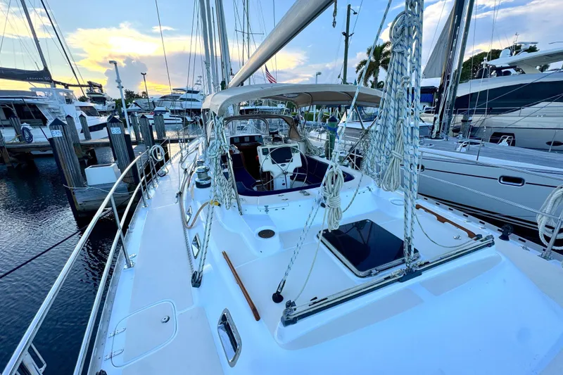 Slide: The Image of 2009 Hylas 54 yacht docked at marina during sunset, showcasing deck and rigging. - 3