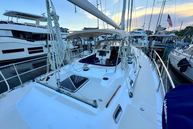Slide: The Image of 2009 Hylas 54 yacht docked at marina, showcasing deck and rigging at sunset. - 4