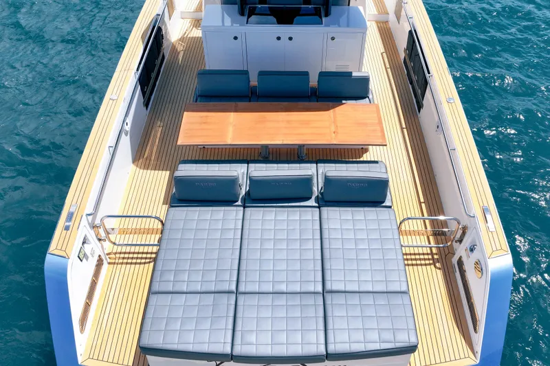 Slide: The Image of Luxurious 2024 Pardo Yachts 43 deck with sunbeds and dining area on the water. - 11