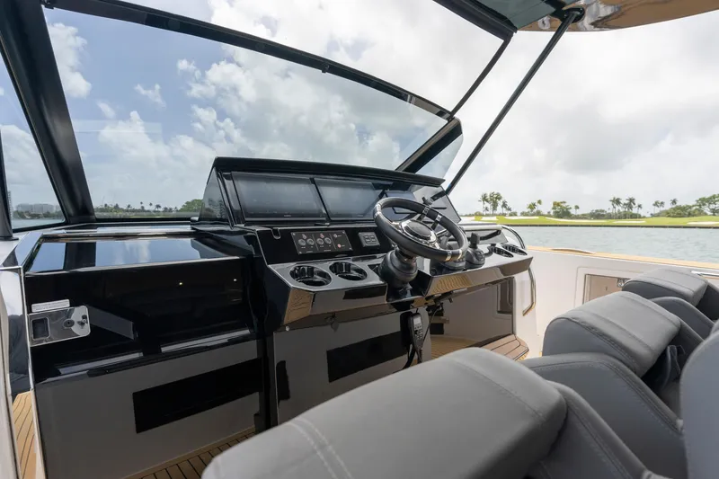 Slide: The Image of 2024 Pardo Yachts 43 helm with modern controls and luxurious seating. - 19