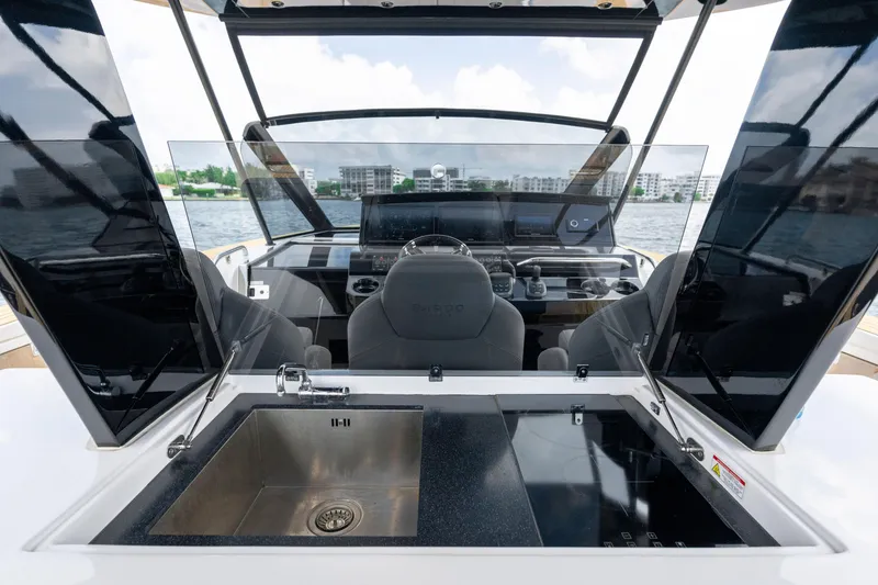 Slide: The Image of 2024 Pardo Yachts 43 cockpit with modern helm, sink, and sleek design on the water. - 26
