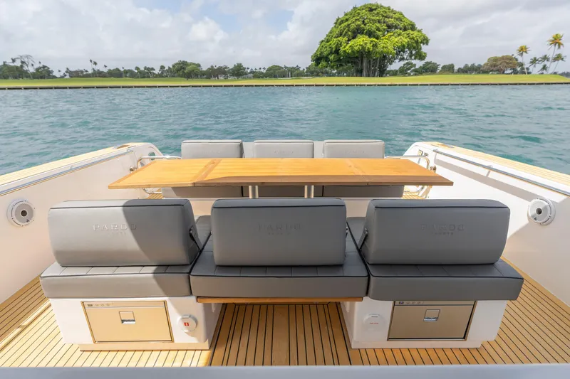 Slide: The Image of Luxury seating area on 2024 Pardo Yachts 43, featuring elegant wood table and scenic water view. - 40