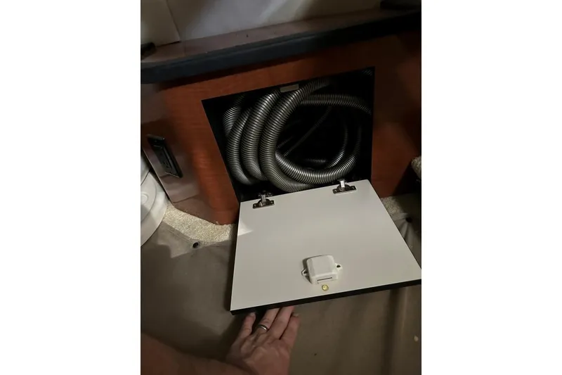 Slide: The Image of Open compartment with coiled hose in 2006 Sea Ray 340 Sundancer boat. - 11