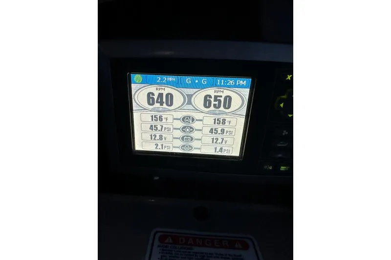 Slide: The Image of Display screen showing engine metrics on a 2006 Sea Ray 340 Sundancer boat. - 14