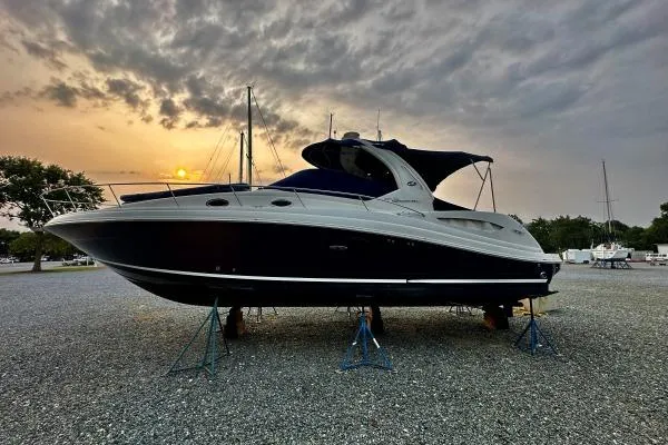 Slide: The Image of 2006 Sea Ray 340 Sundancer yacht on stands at sunset, gravel lot. - 3