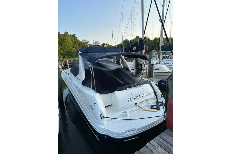 Slide: The Image of 2006 Sea Ray 340 Sundancer docked at marina, covered with navy blue canopy. - 7