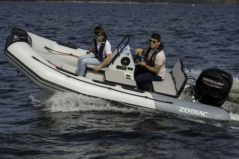 Slide: The Image of Manufacturer Provided Image: Zodiac Open 4.2 boat 2026 on water with two people. - 1