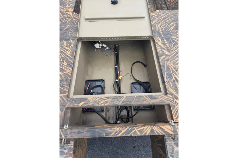 Slide: The Image of Open storage compartment of 2026 G3 Gator Tough 16 DK boat. - 4