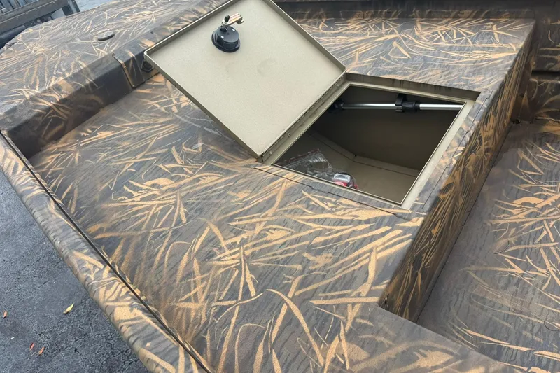 Slide: The Image of 2026 G3 Gator Tough 16 DK boat with open storage compartment, camo pattern. - 6