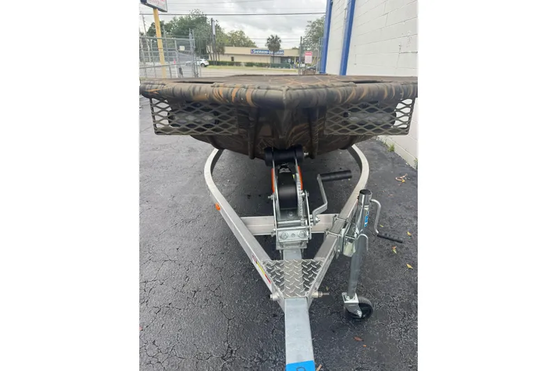 Slide: The Image of 2026 G3 Gator Tough 16 DK boat on trailer, camo design, parked outdoors. - 7