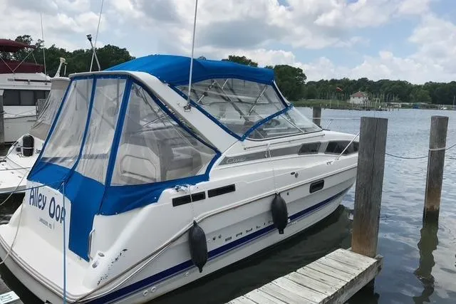 The Image of 1994 Bayliner 2855 Ciera boat docked with blue canopy and clear windows. - 0