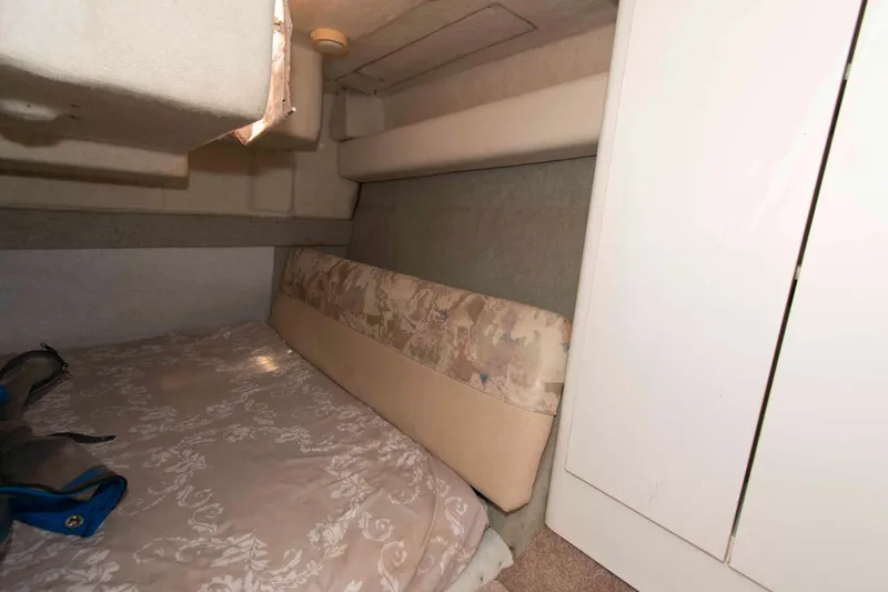 Slide: The Image of 1994 Bayliner 2855 Ciera cabin interior with bed and storage space. - 10