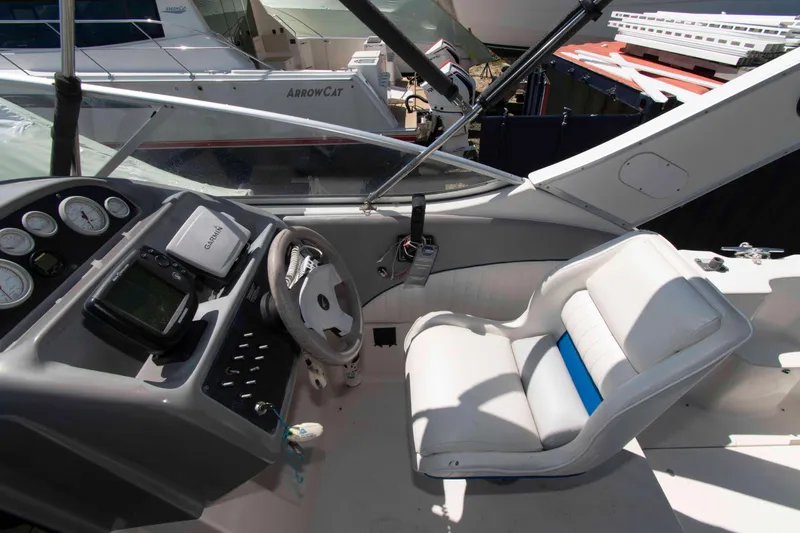 Slide: The Image of 1994 Bayliner 2855 Ciera cockpit with steering wheel, gauges, and white seating. - 4