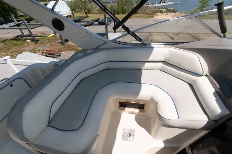 Slide: The Image of 1994 Bayliner 2855 Ciera boat interior with white cushioned seating and waterfront view. - 5