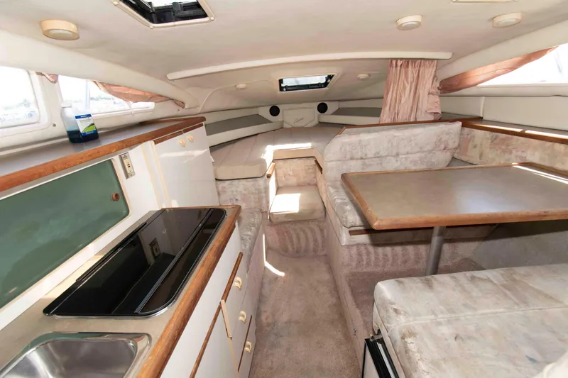 Slide: The Image of Interior of a 1994 Bayliner 2855 Ciera boat with kitchen and seating area. - 6