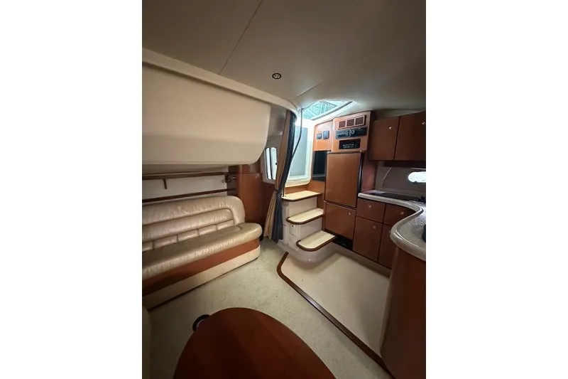 Slide: The Image of Luxurious interior of 2003 Four Winns 378 Vista yacht with leather seating and wooden cabinetry. - 10