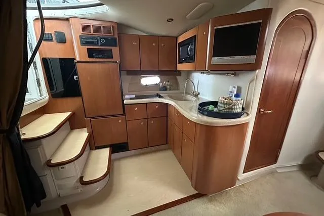 Slide: The Image of 2003 Four Winns 378 Vista yacht interior with wooden cabinetry and modern amenities. - 11