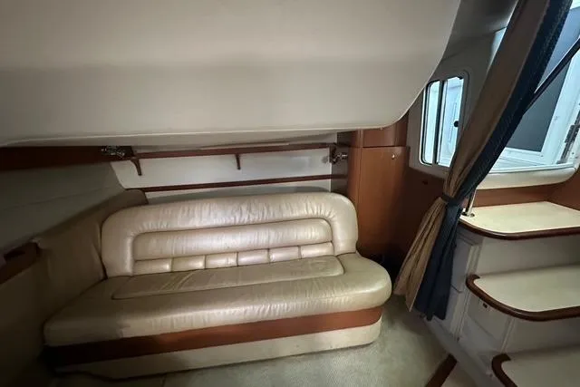 Slide: The Image of Interior of 2003 Four Winns 378 Vista yacht with beige leather seating and wooden accents. - 12