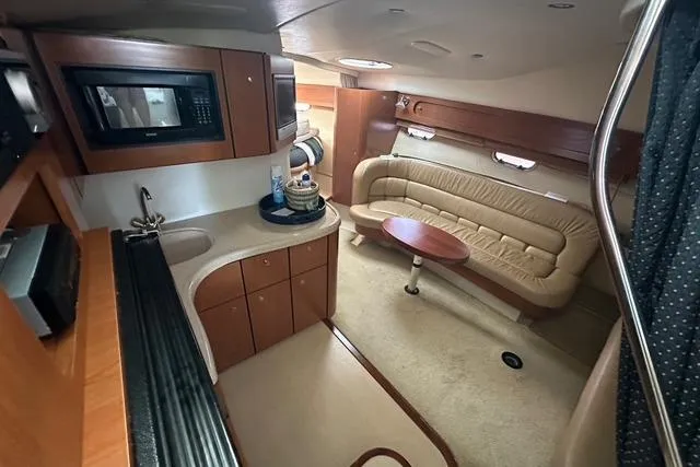 Slide: The Image of Luxurious interior of 2003 Four Winns 378 Vista yacht with kitchenette and seating area. - 14