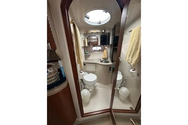 Slide: The Image of Bathroom interior of 2003 Four Winns 378 Vista yacht, featuring toilet and sink. - 15