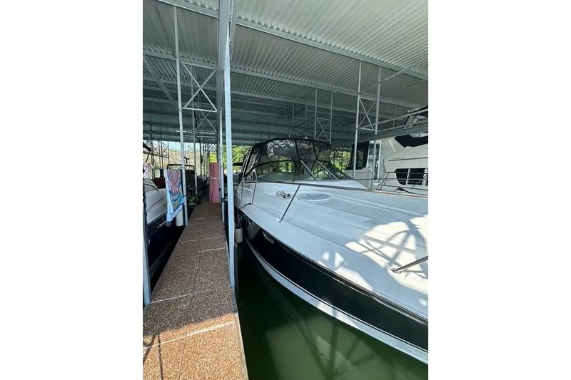 Slide: The Image of 2003 Four Winns 378 Vista boat docked in covered marina. - 2