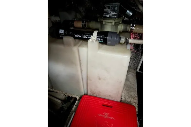 Slide: The Image of Engine compartment of 2003 Four Winns 378 Vista boat, featuring water tanks and filtration system. - 23