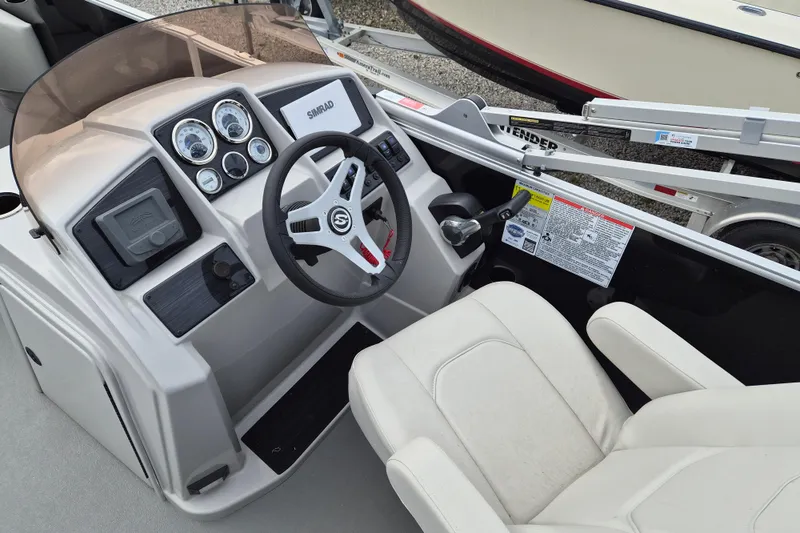 Slide: The Image of Cockpit of 2025 Sylvan Mirage Fish 8522 Party Fish 4.0 with steering wheel and controls. - 10