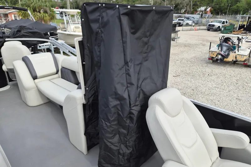 Slide: The Image of 2025 Sylvan Mirage Fish 8522 Party Fish 4.0 boat interior with seating and privacy curtain. - 6