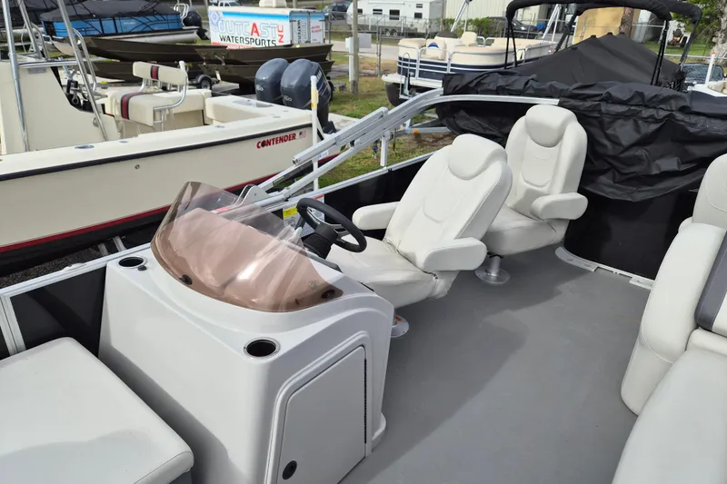 Slide: The Image of 2025 Sylvan Mirage Fish 8522 Party Fish 4.0 interior with comfortable seating and steering console. - 7