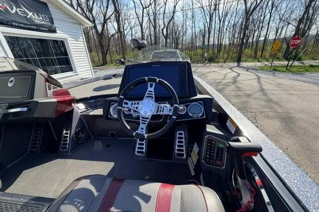 Slide: The Image of 2021 Ranger Z520L Cup-Equipped boat cockpit with steering wheel and dashboard controls. - 26