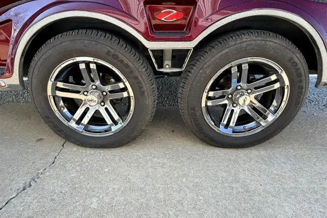Slide: The Image of 2021 Ranger Z520L Cup-Equipped trailer wheels with chrome rims on concrete surface. - 33