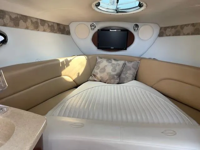 Slide: The Image of Luxurious interior of 2023 Crownline 270 CR boat with cozy seating and TV. - 25