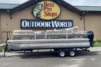 The Image of 2023 Sun Tracker SportFish 22 DLX pontoon boat outside Bass Pro Shops Outdoor World. - 1